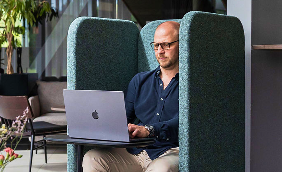 Man som arbetar vid sin dator i Arenahotellets lounge