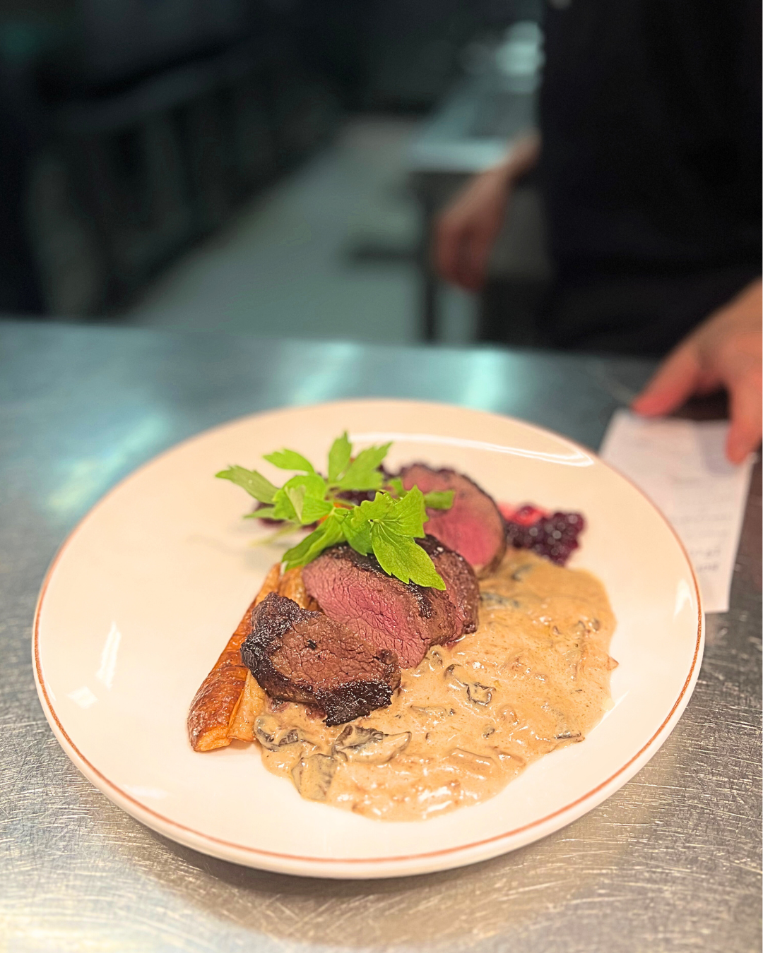 A plate with meat sauce and root vegetables
